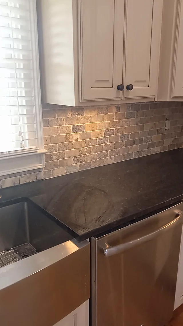 Later-stage kitchen backsplash beside the farmhouse sink, extracted from the matching project video