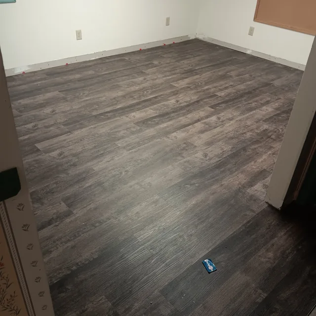 Gray wood-look plank flooring installed across an interior room